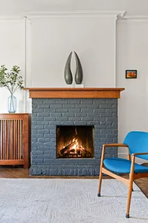 a living room with a couch a rug and a fireplace