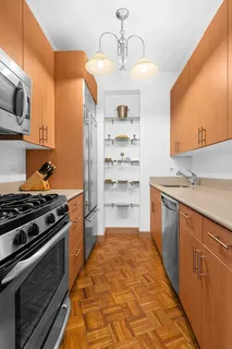 a kitchen with stainless steel appliances a stove and a microwave