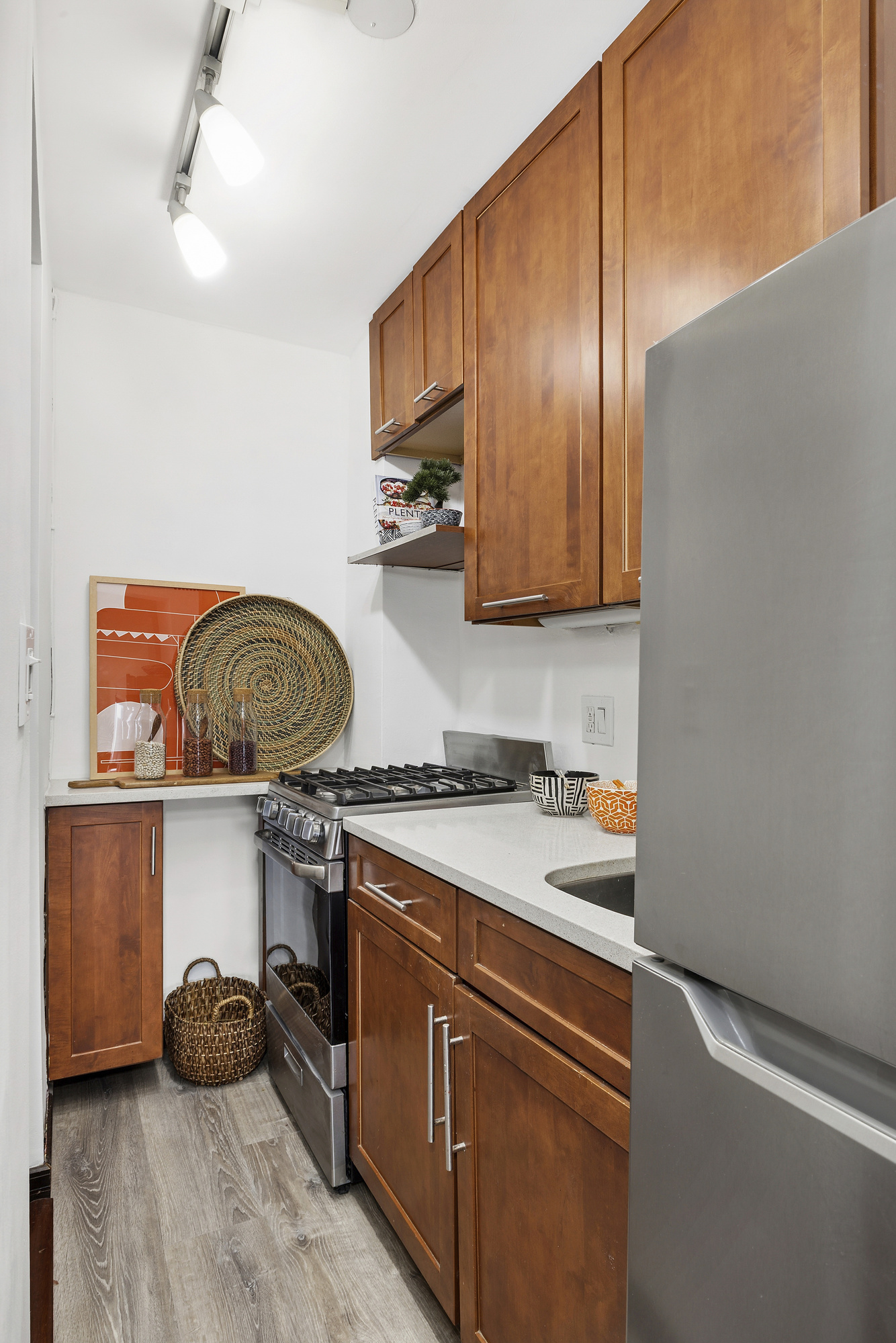 195 Willoughby Avenue, Unit 905 Brooklyn, NY 11205 - Photo 5 of 7 a kitchen with stainless steel appliances granite countertop a sink a stove and a wooden floors