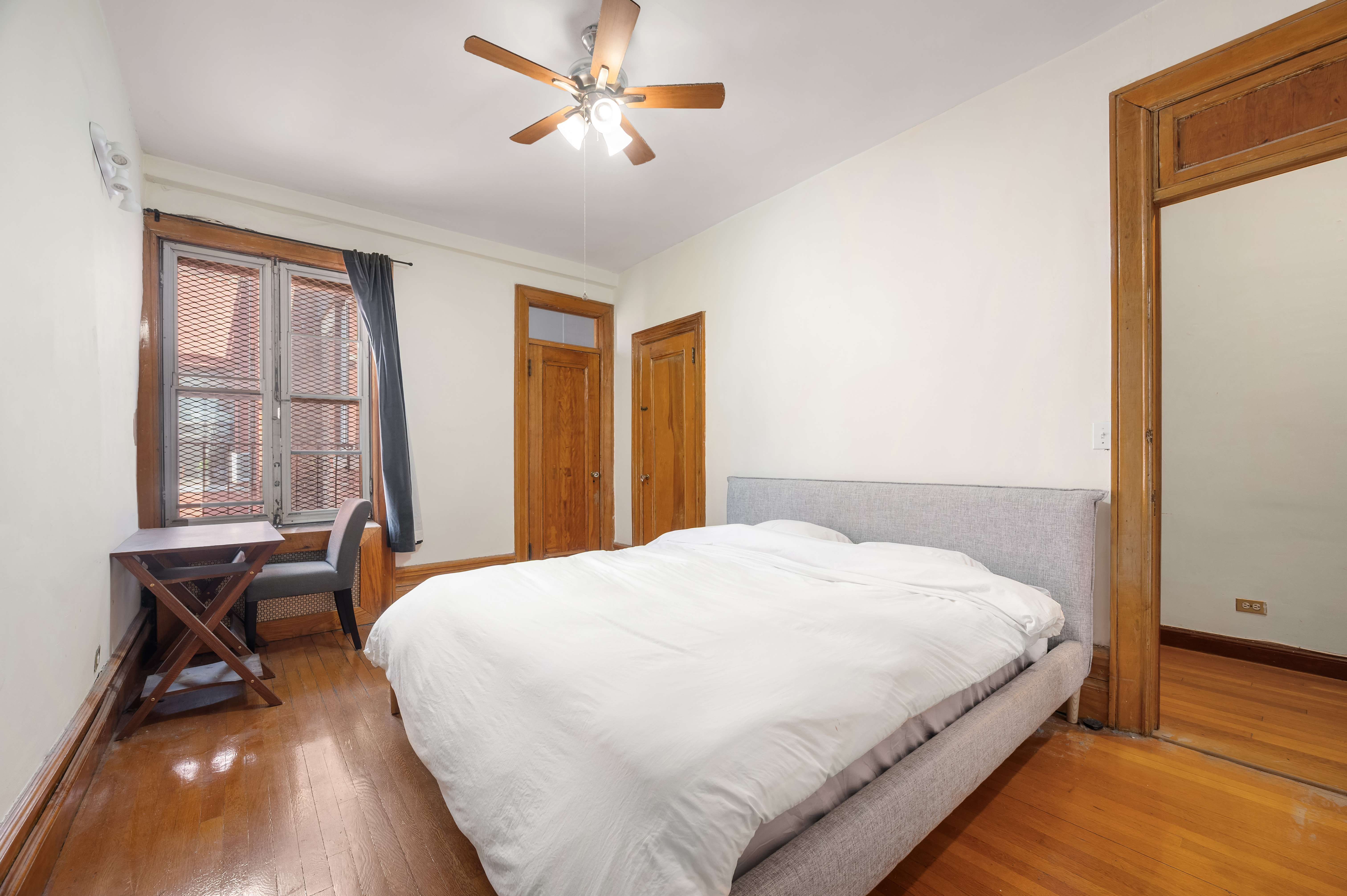 504-510 West 110th Street, Unit 12E Manhattan, NY 10025 - Photo 3 of 6 a bedroom with a bed and wooden floor