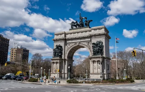 an aerial view of a swimming pool with outdoor seating