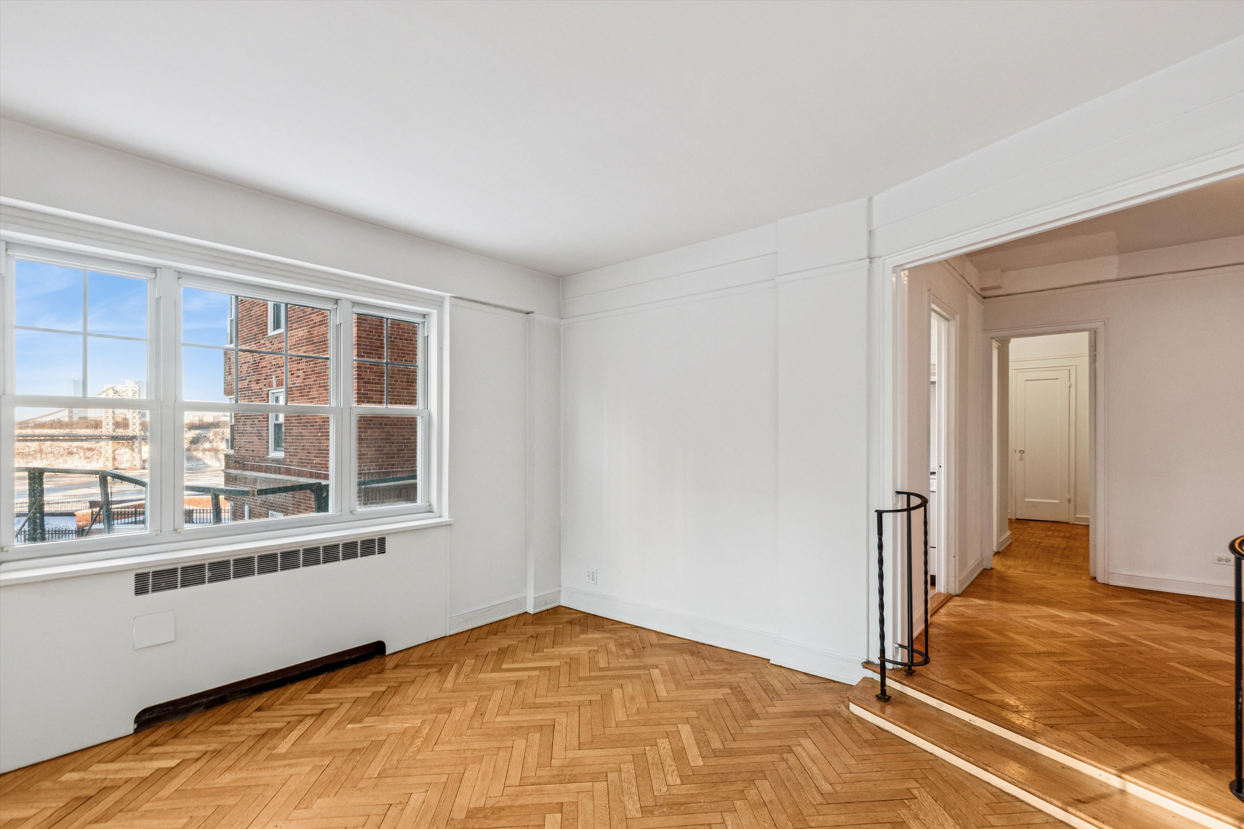 200 Cabrini Boulevard, Unit 10 Manhattan, NY 10033 - Photo 8 of 35 a view of an empty room with wooden floor and a window
