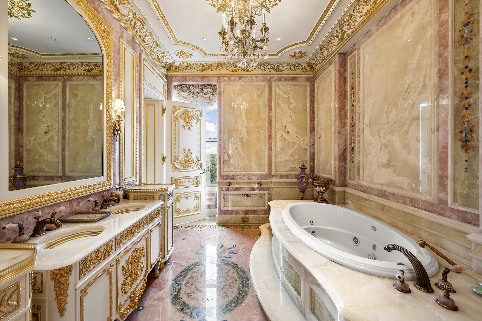 1 Central Park South, Unit 10071009 Manhattan, NY 10019 - Photo 13 of 28 a bathroom with a tub a sink a large mirror and a bathtub next to a window
