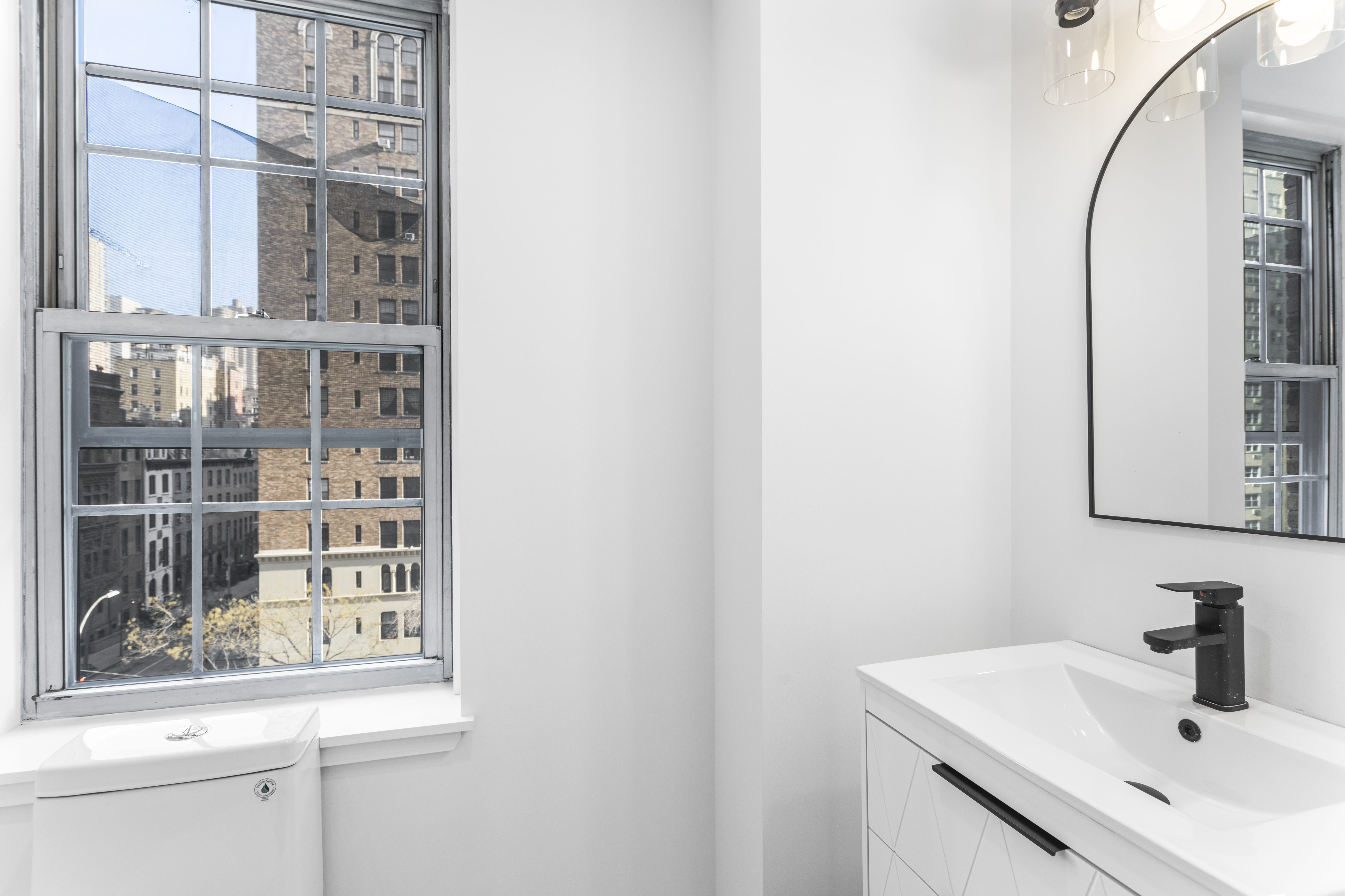16 Park Avenue, Unit 6CD Manhattan, NY 10016 - Photo 8 of 12 a bathroom with a sink and a mirror