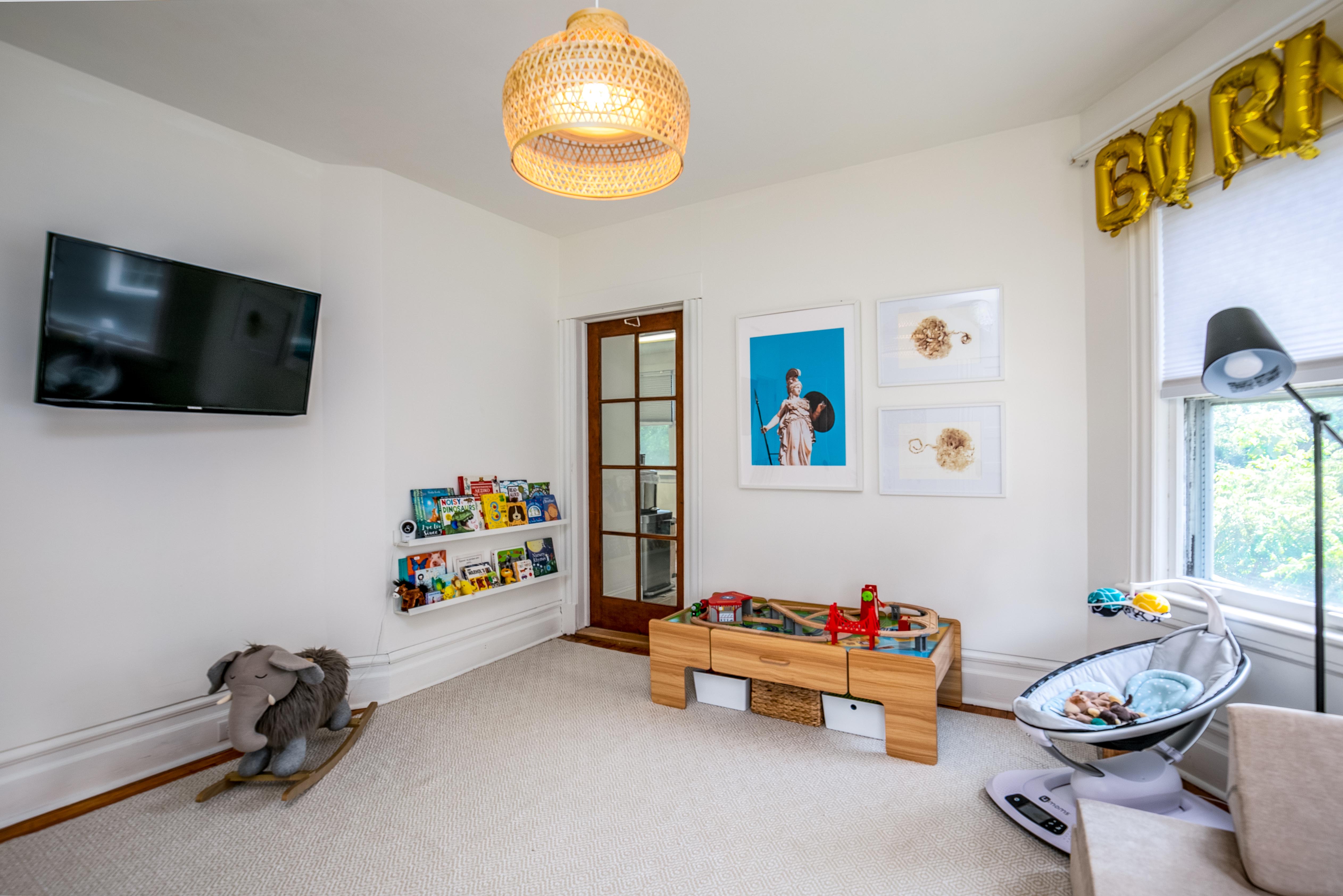 163 Ridge Road Rutherford, NJ 07070 - Photo 35 of 59 a children room with toys and a flat screen tv