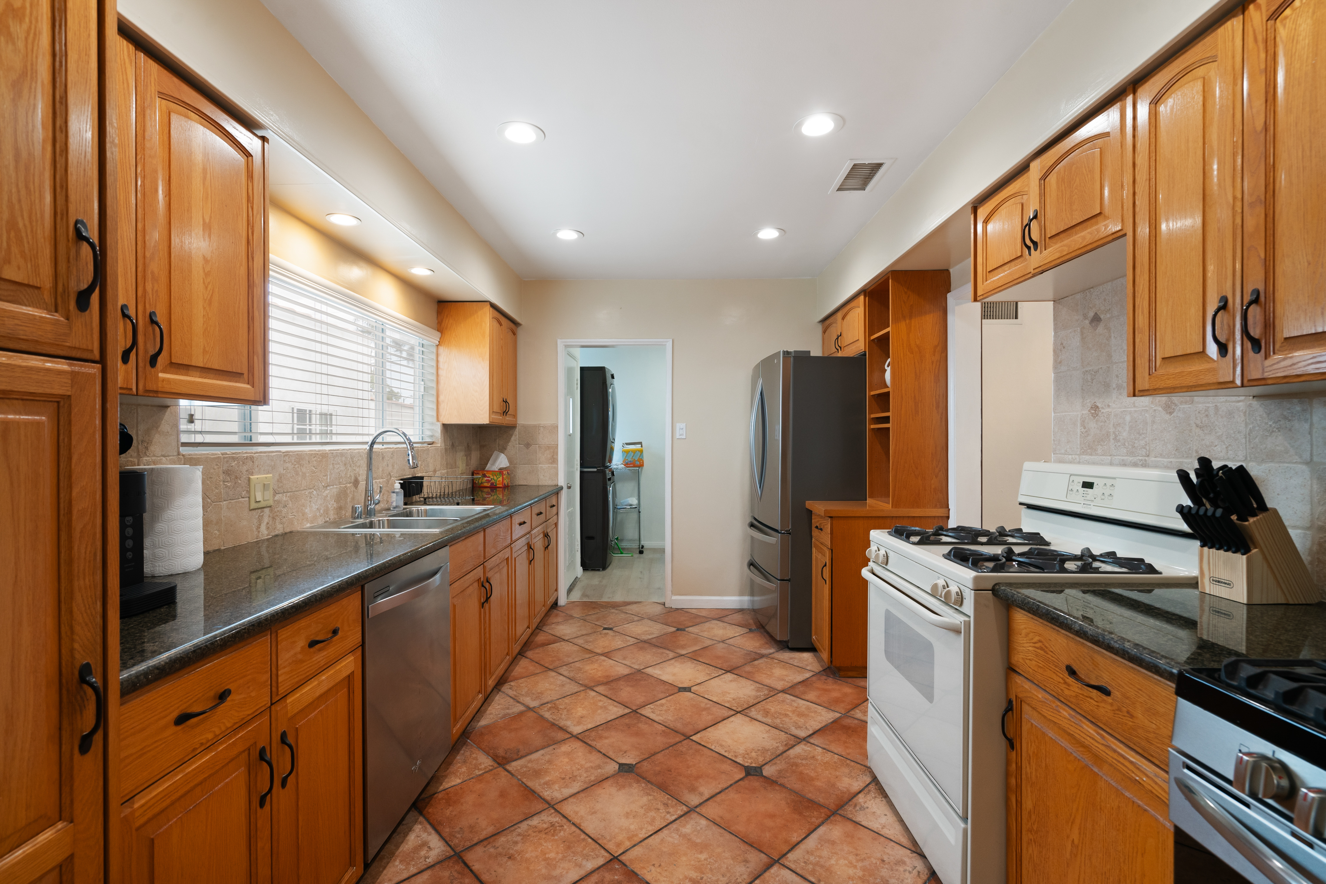 8832 Horner Street Los Angeles, CA 90035 - Photo 10 of 24 a kitchen with stainless steel appliances granite countertop a stove a sink and a refrigerator