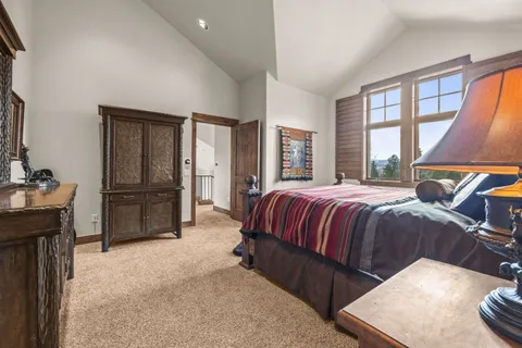a spacious bedroom with a bed and glass windows