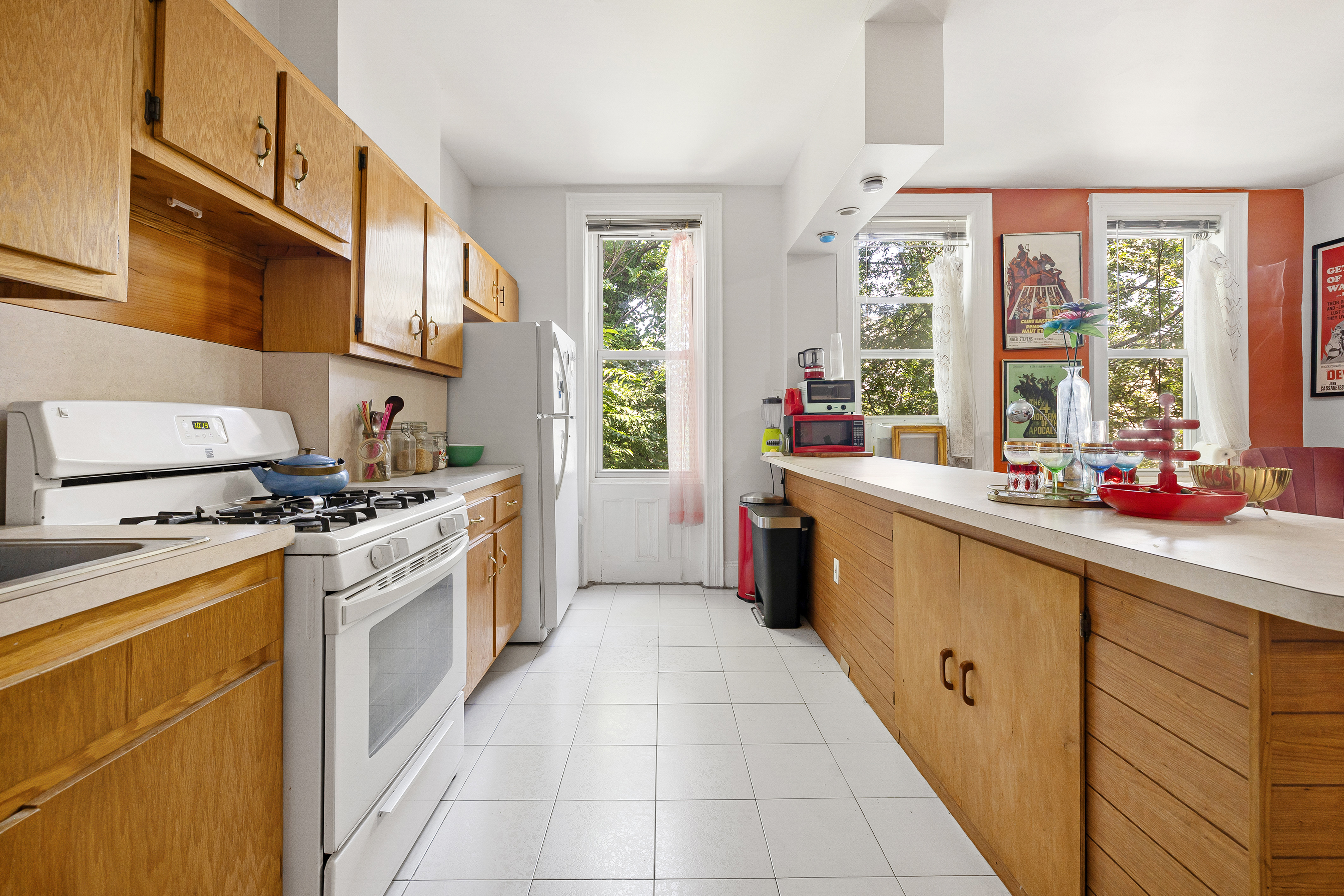 59-47 Madison Street, Unit 2 Queens, NY 11385 - Photo 2 of 12 a kitchen with stainless steel appliances a stove sink and cabinets