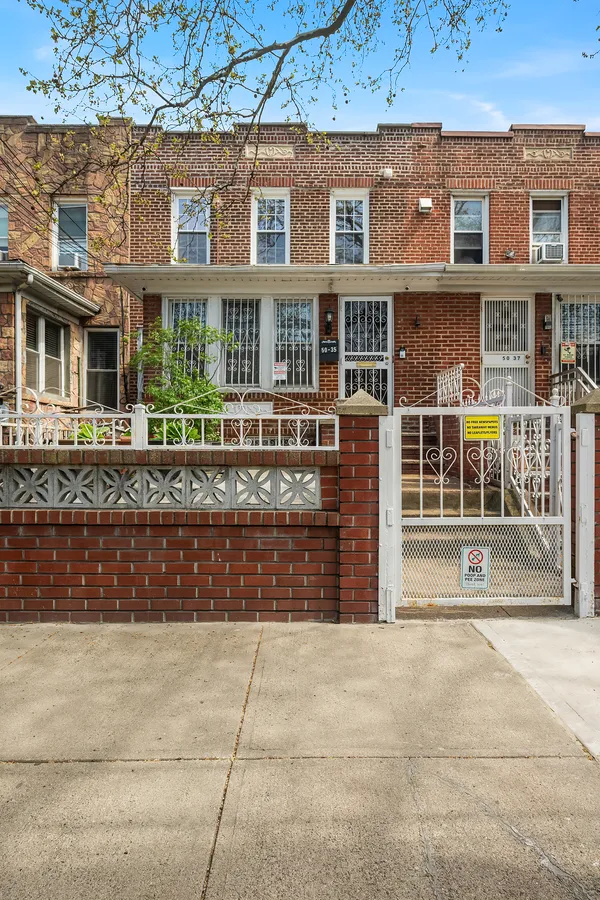 front view of a brick house with a large windows
