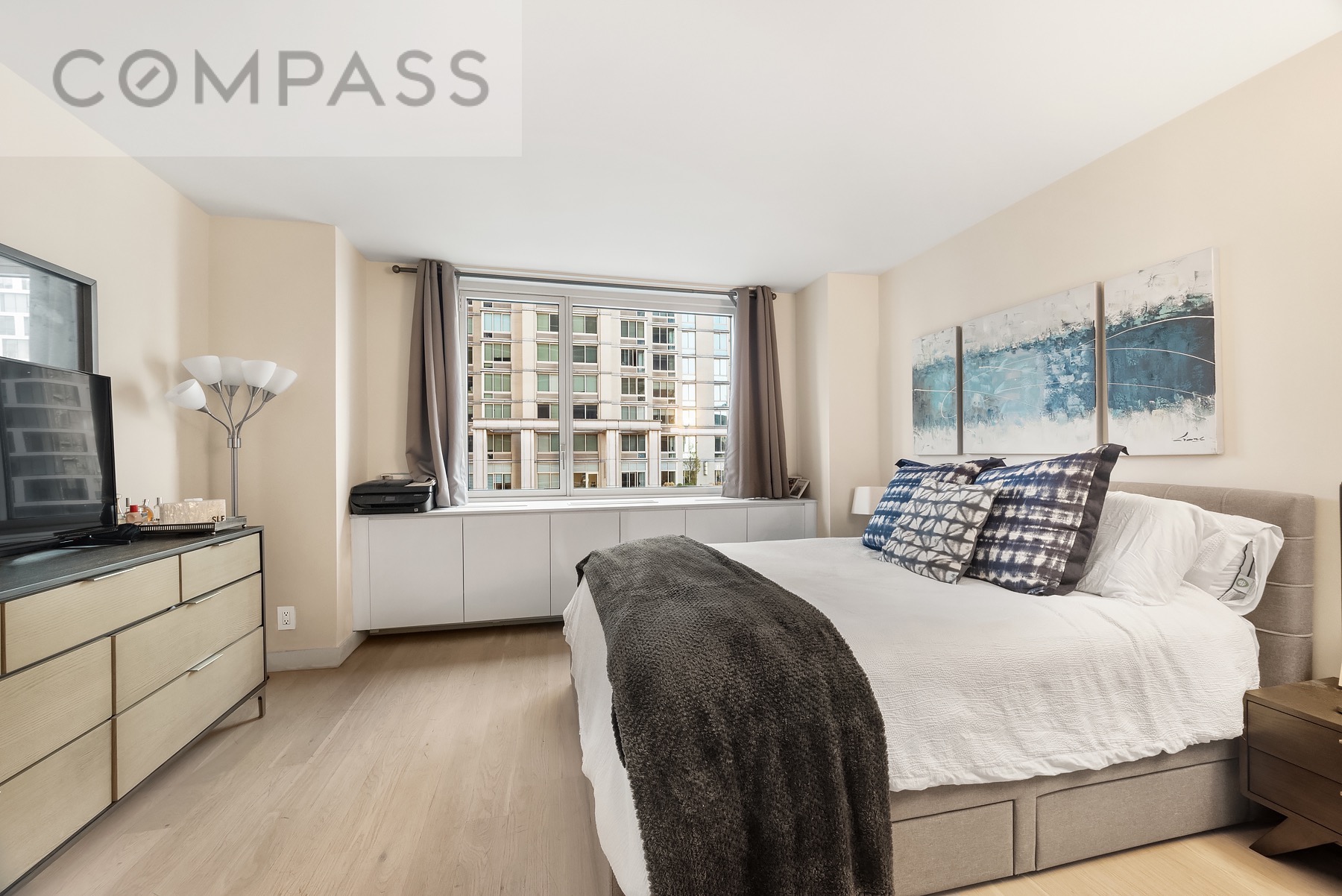 301 West 53rd Street, Unit 7H Manhattan, NY 10019 - Photo 4 of 11 a bedroom with a large bed and a window