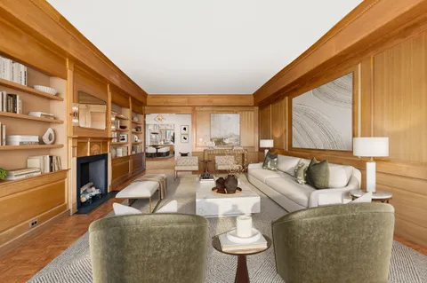 a living room with furniture fireplace and a large window