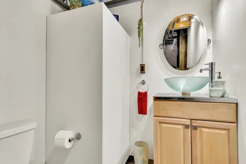 a bathroom with a sink a mirror and shower
