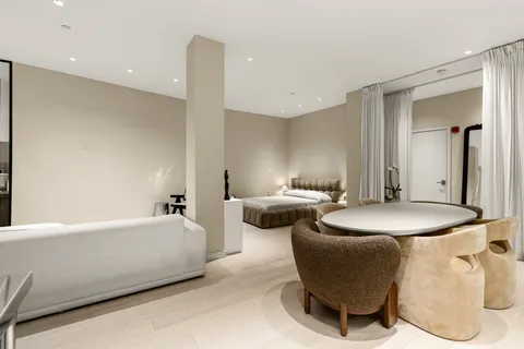 a spacious bedroom with a bed and a couch