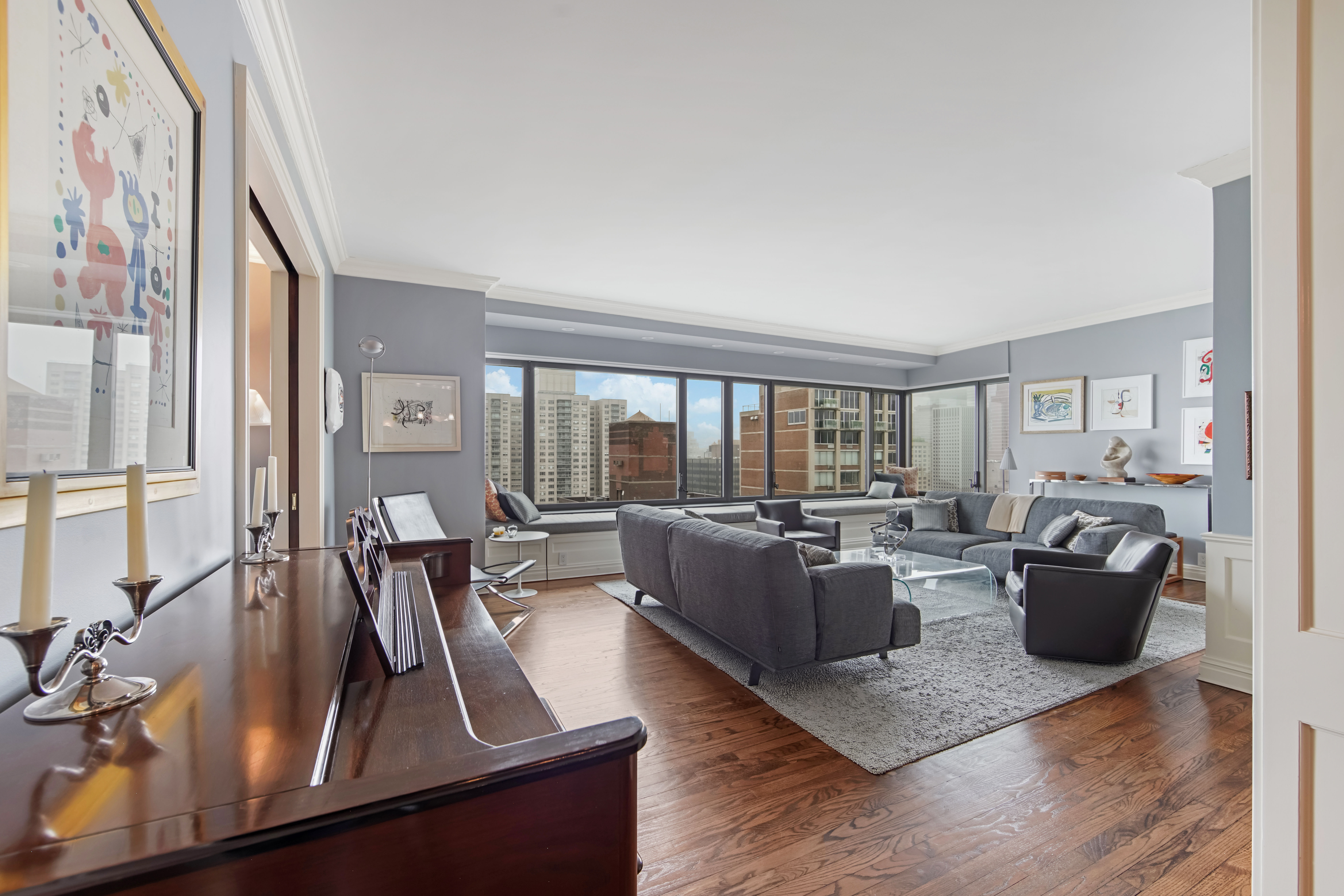 425 East 58th Street, Unit 29C Manhattan, NY 10022 - Photo 1 of 9 a living room with furniture large window and wooden floor