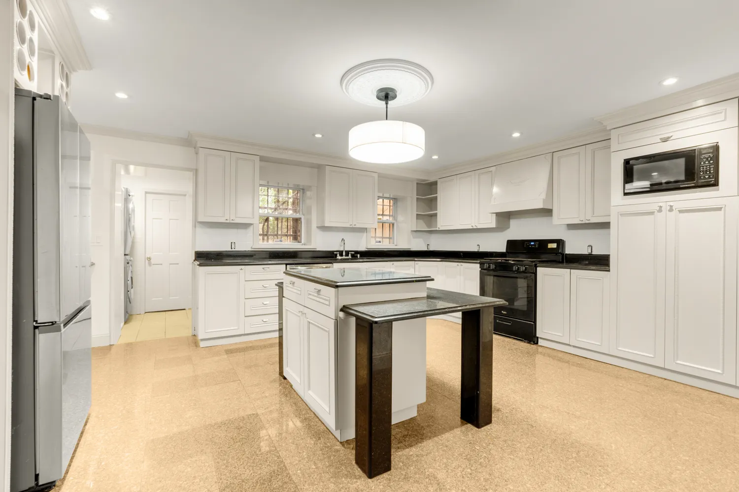 a kitchen with cabinets and stainless steel appliances