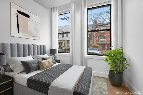a bed room with bed and a potted plant