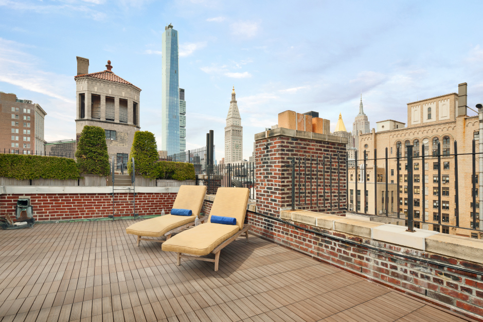 44 Gramercy Park North, Unit 8B Manhattan, NY 10010 - Photo 8 of 10 a roof deck with a barbeque and wooden stairs