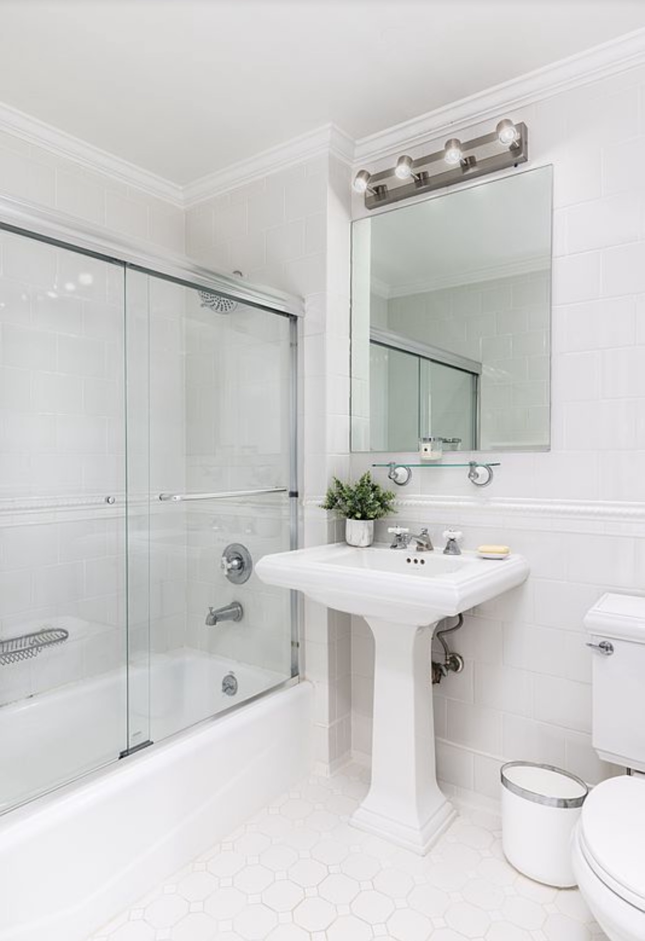 404 East 76th Street, Unit 30A Manhattan, NY 10021 - Photo 9 of 17 a bathroom with a sink toilet and shower