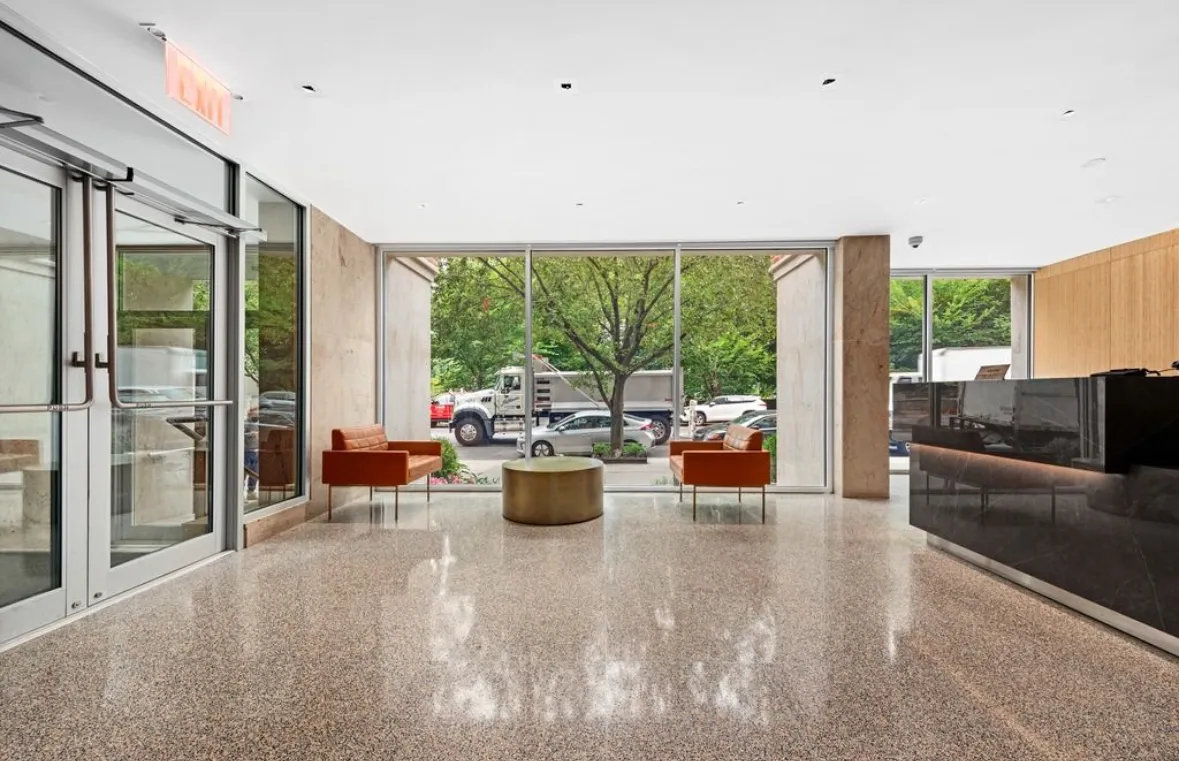a view of a living room with furniture potted plant and a large window