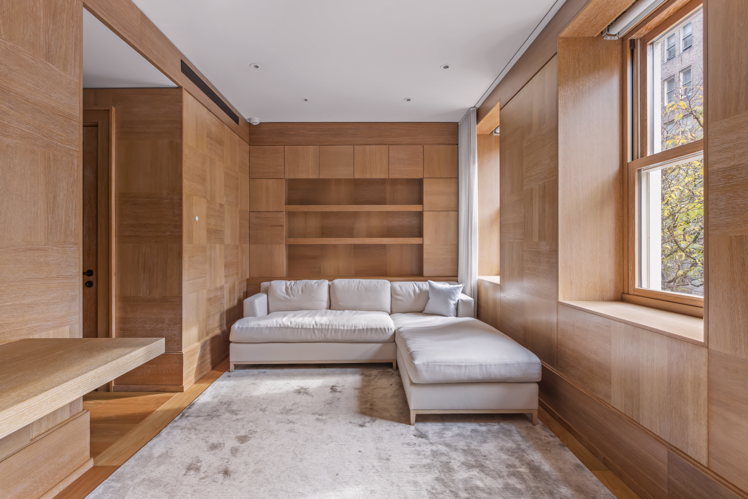 45 East 74th Street Manhattan, NY 10021 - Photo 21 of 33 a living room with furniture and a window