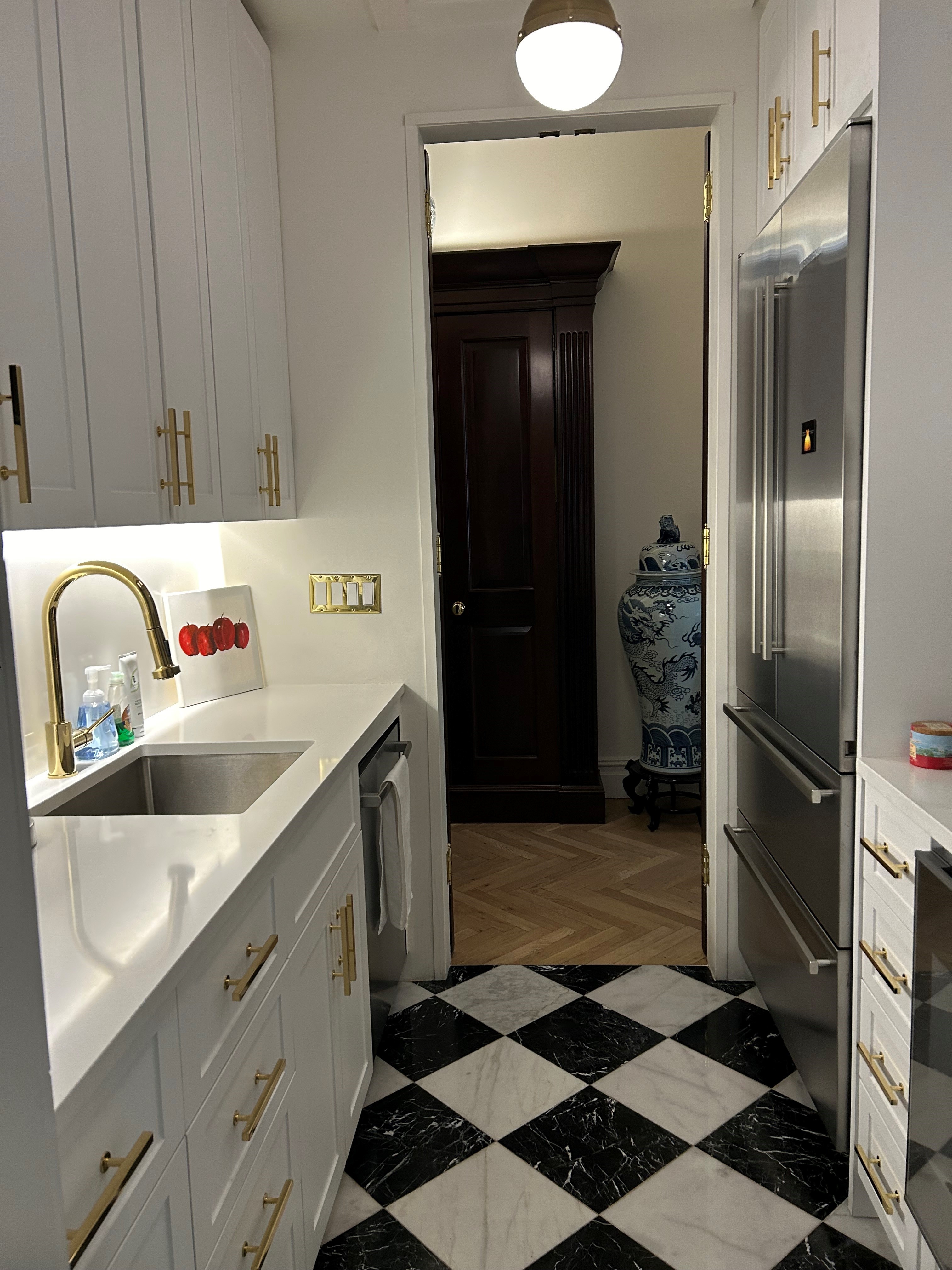 36 East 69th Street, Unit 2AB Manhattan, NY 10021 - Photo 16 of 26 a kitchen with a sink and a refrigerator
