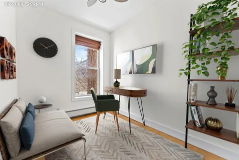 a living room with furniture and a potted plant