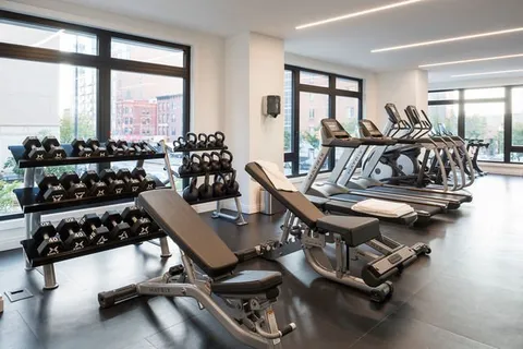 a room with gym equipment and a large window