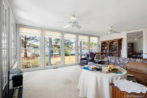 a living room with furniture and large windows