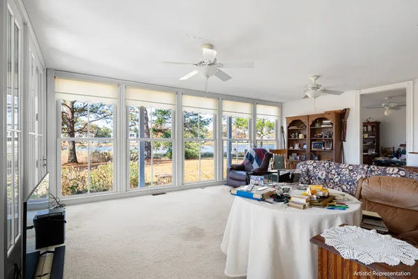 a living room with furniture and large windows