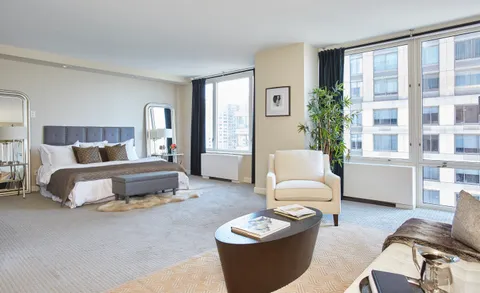 a bedroom with a bed and a couch