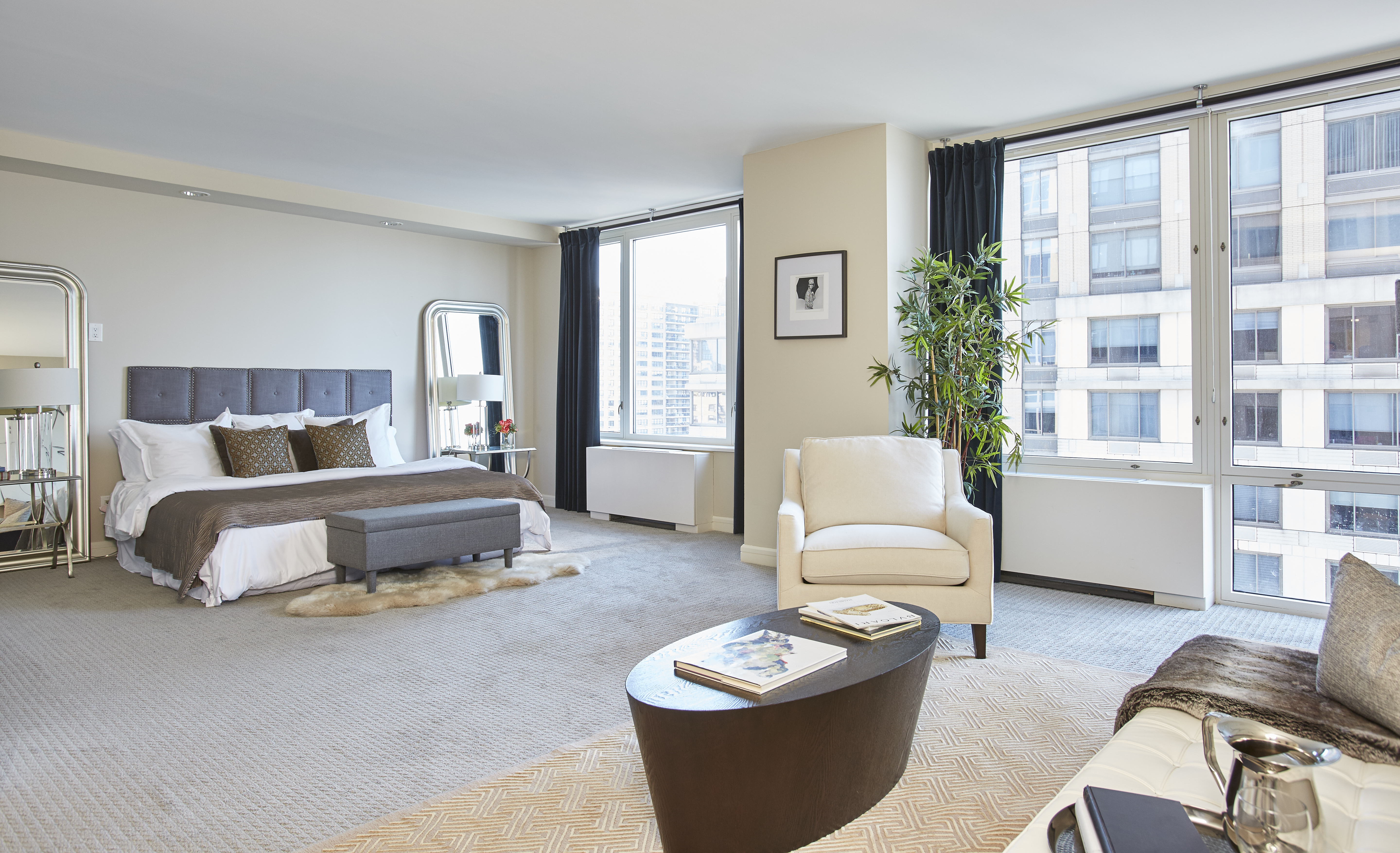 220 Riverside Boulevard, Unit 19JG Manhattan, NY 10069 - Photo 4 of 13 a bedroom with a bed and a couch