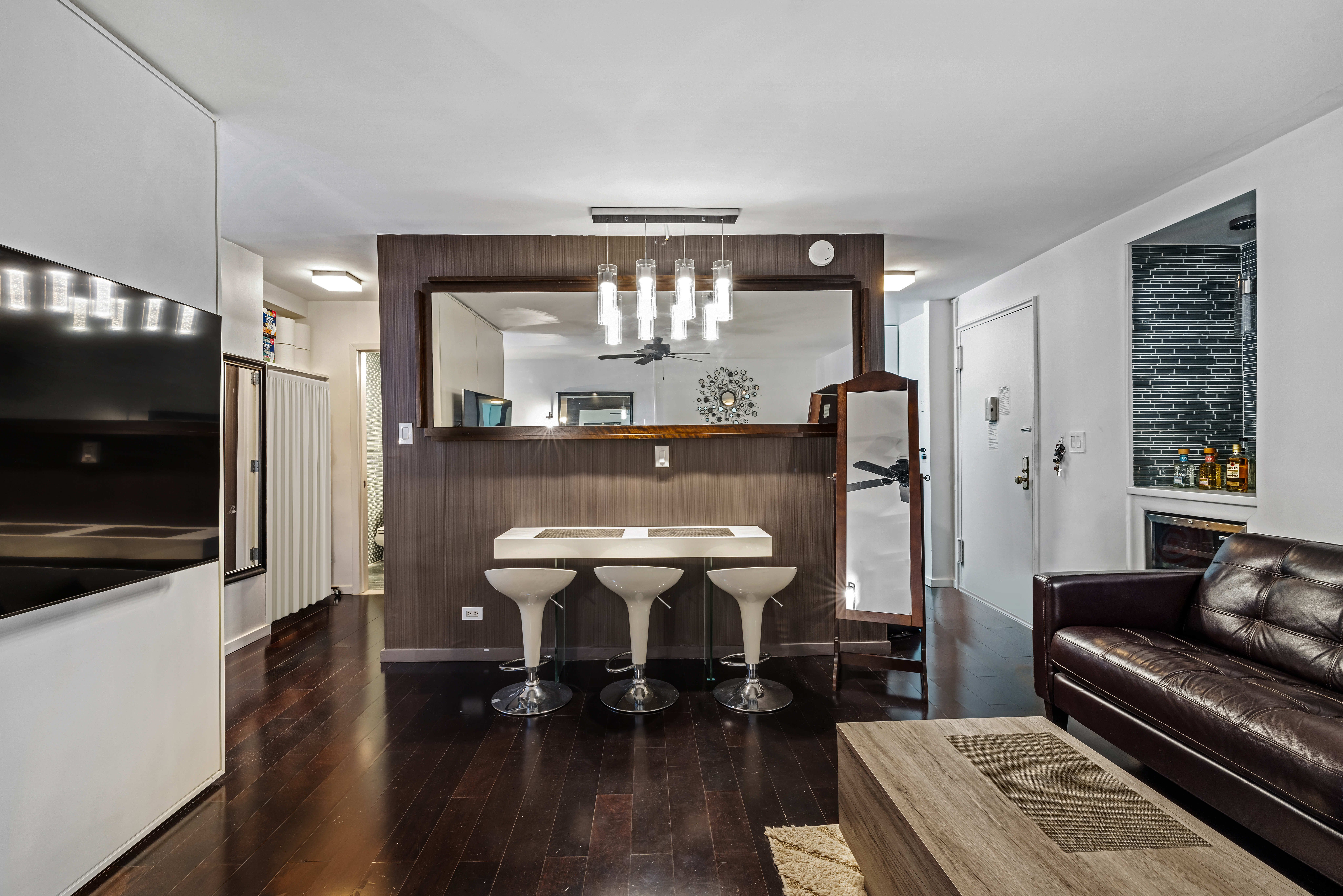 139 East 33rd Street, Unit 3M Manhattan, NY 10016 - Photo 3 of 11 a living room with furniture and a flat screen tv