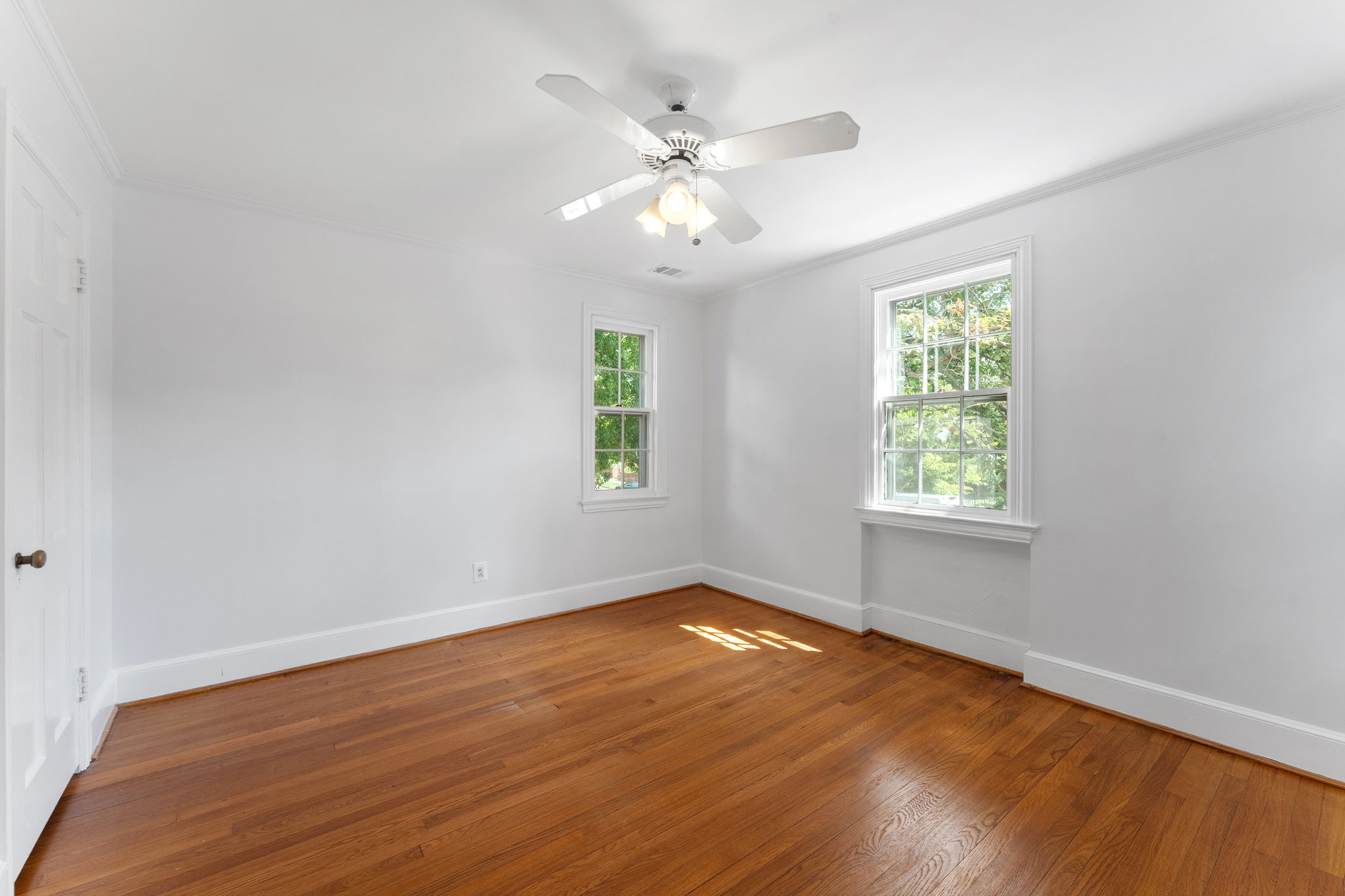 1325 Locust Road Northwest Washington, DC 20012 - Photo 35 of 56 an empty room with wooden floor fan and windows