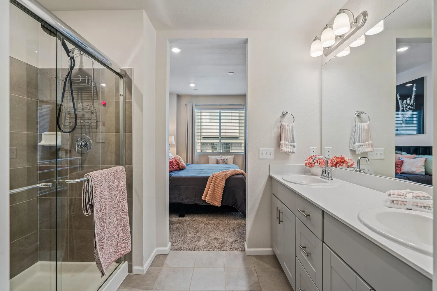 a bathroom with a double vanity sink mirror and shower