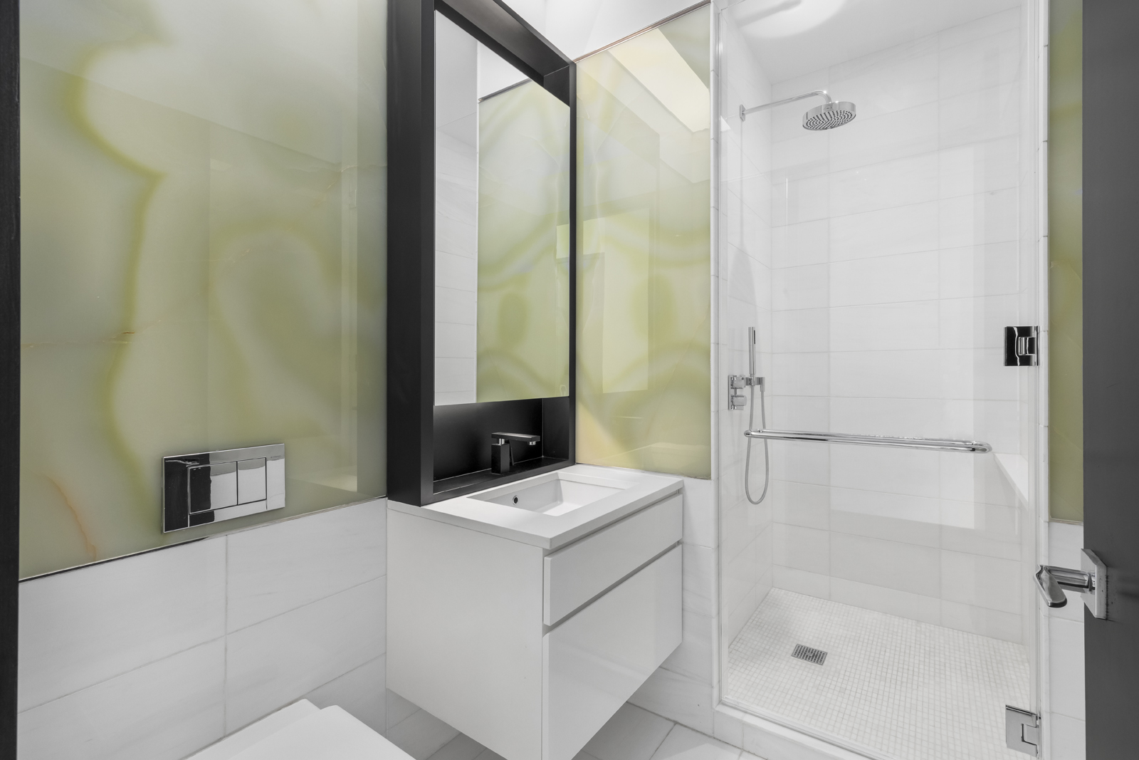 157 West 57th Street, Unit 56C Manhattan, NY 10019 - Photo 11 of 12 a bathroom with a tub sink vanity and a mirror