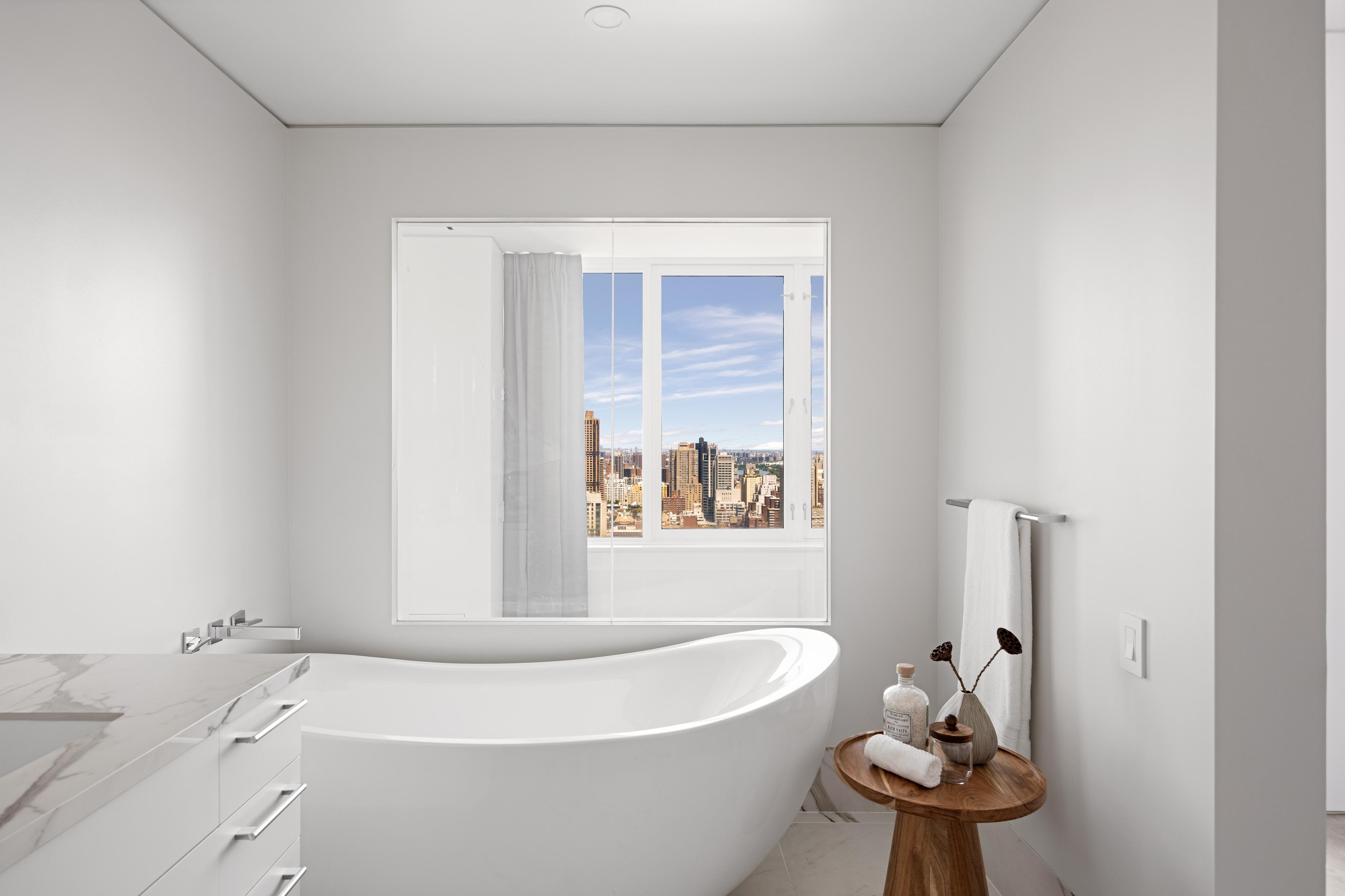 422 East 72nd Street, Unit 37AD Manhattan, NY 10021 - Photo 22 of 38 a white bath tub sitting next to a white sink
