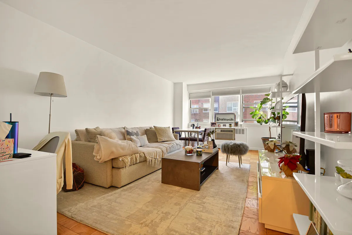 245 East 35th Street, Unit 9D Manhattan, NY 10016 - Photo 1 of 8 a living room with furniture and a flat screen tv