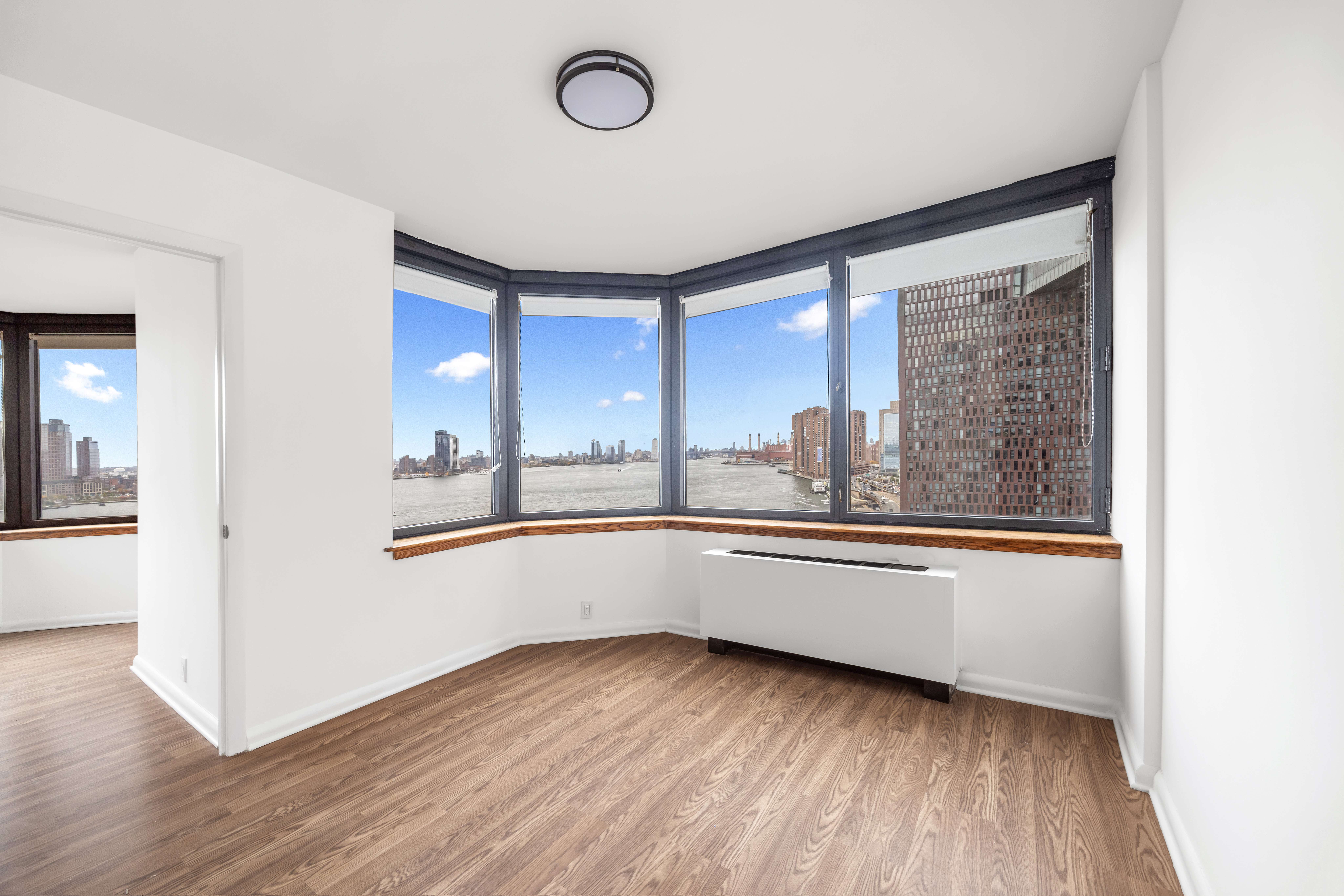 415 East 37th Street, Unit 16F Manhattan, NY 10016 - Photo 7 of 10 a kitchen with wooden floors and wide window