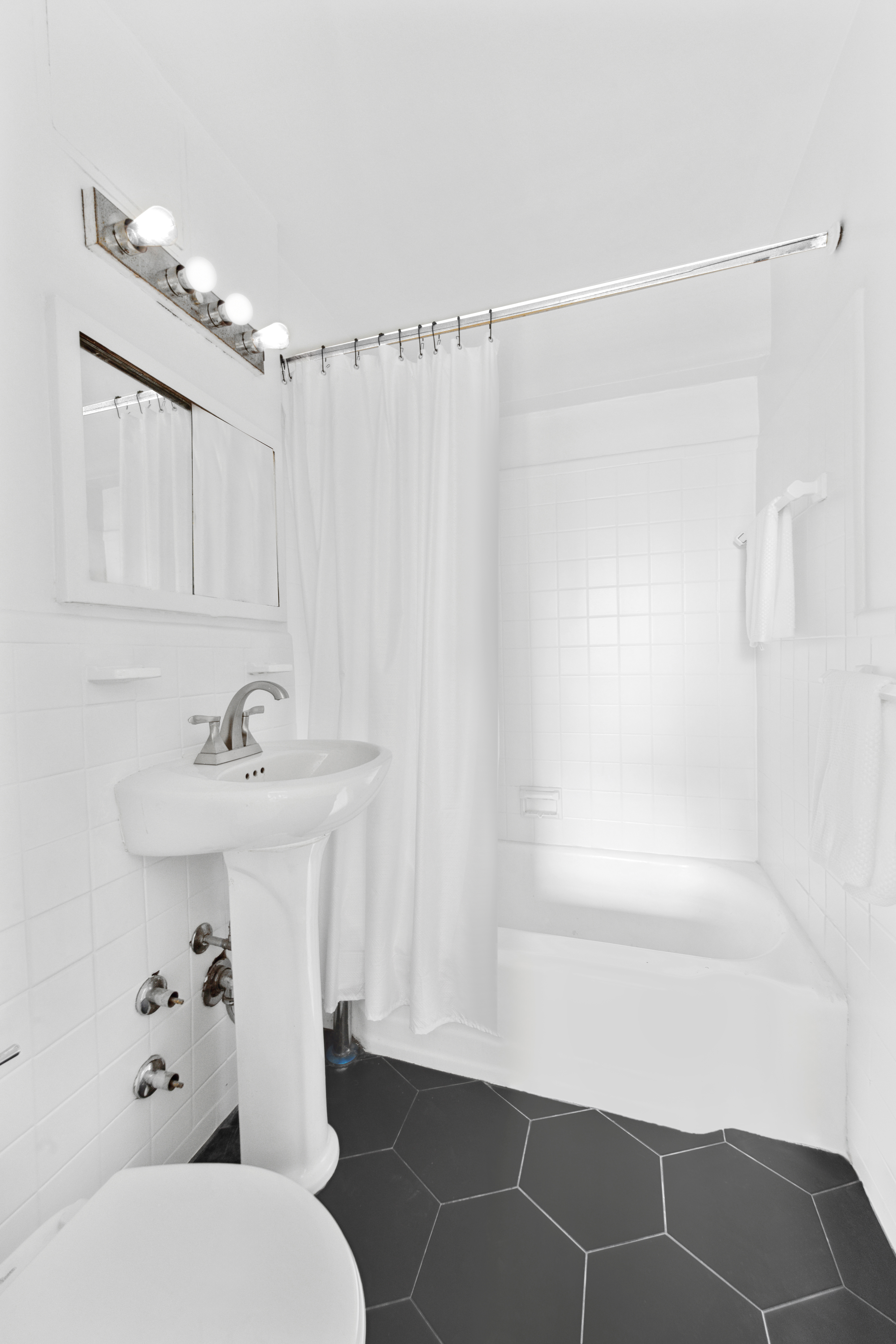 229 East 28th Street, Unit 6D Manhattan, NY 10016 - Photo 5 of 6 a bathroom with a sink toilet and shower