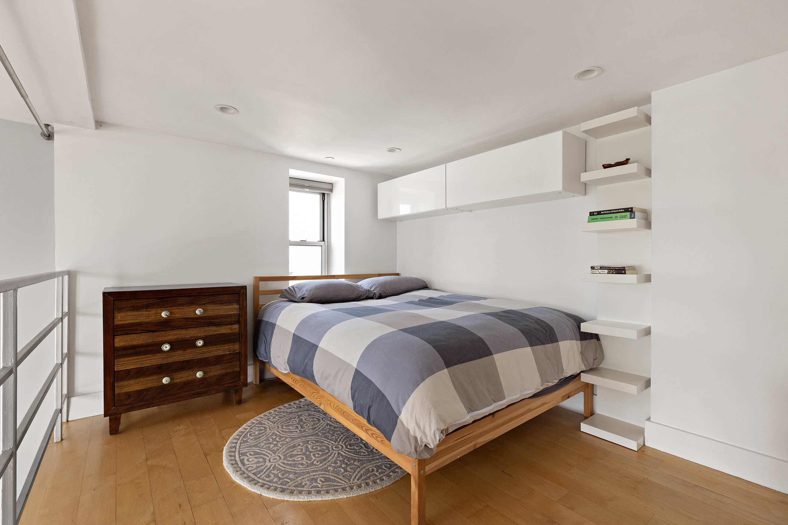 447 Humboldt Street, Unit PHB Brooklyn, NY 11211 - Photo 7 of 10 a bedroom with a bed a dresser and a window