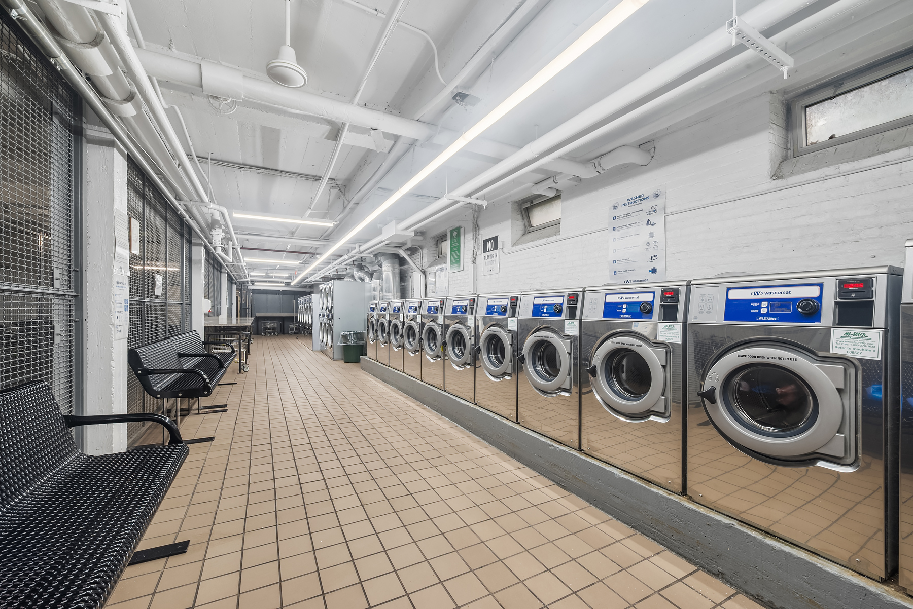 30-31 Hobart Street, Unit 3L Queens, NY 11377 - Photo 13 of 14 a utility room with dryer washer and a rug