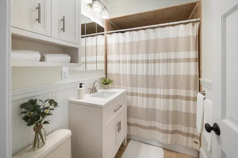 a bathroom with a sink a mirror and a shower