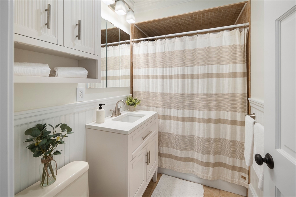 48-50 Amsden Street, Unit 2 Arlington, MA 02474 - Photo 16 of 34 a bathroom with a sink a mirror and a shower