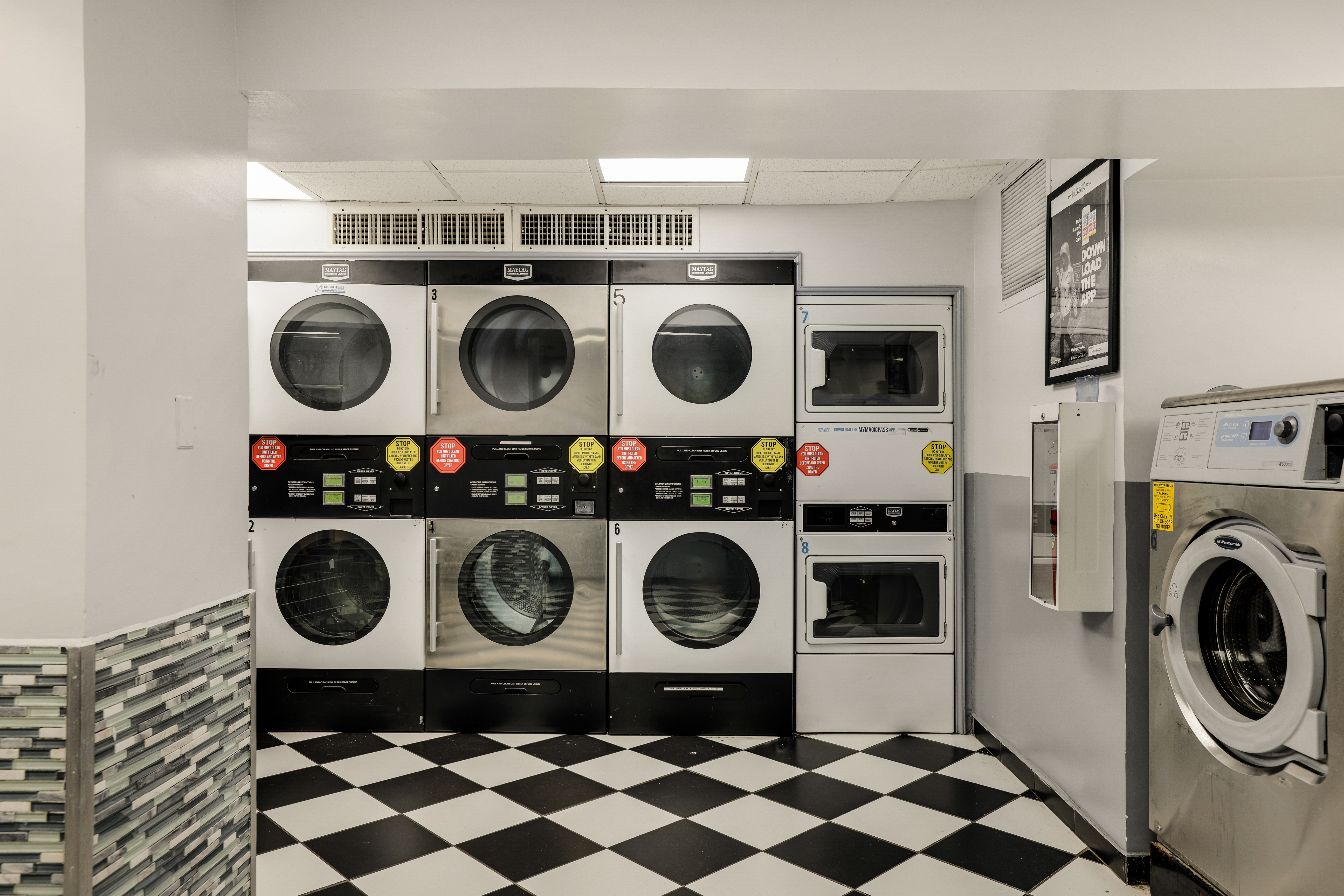 340 West 57th Street, Unit 8E Manhattan, NY 10019 - Photo 10 of 16 a utility room with a stove a washer and dryer