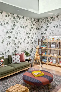 a living room with a couch and painted walls