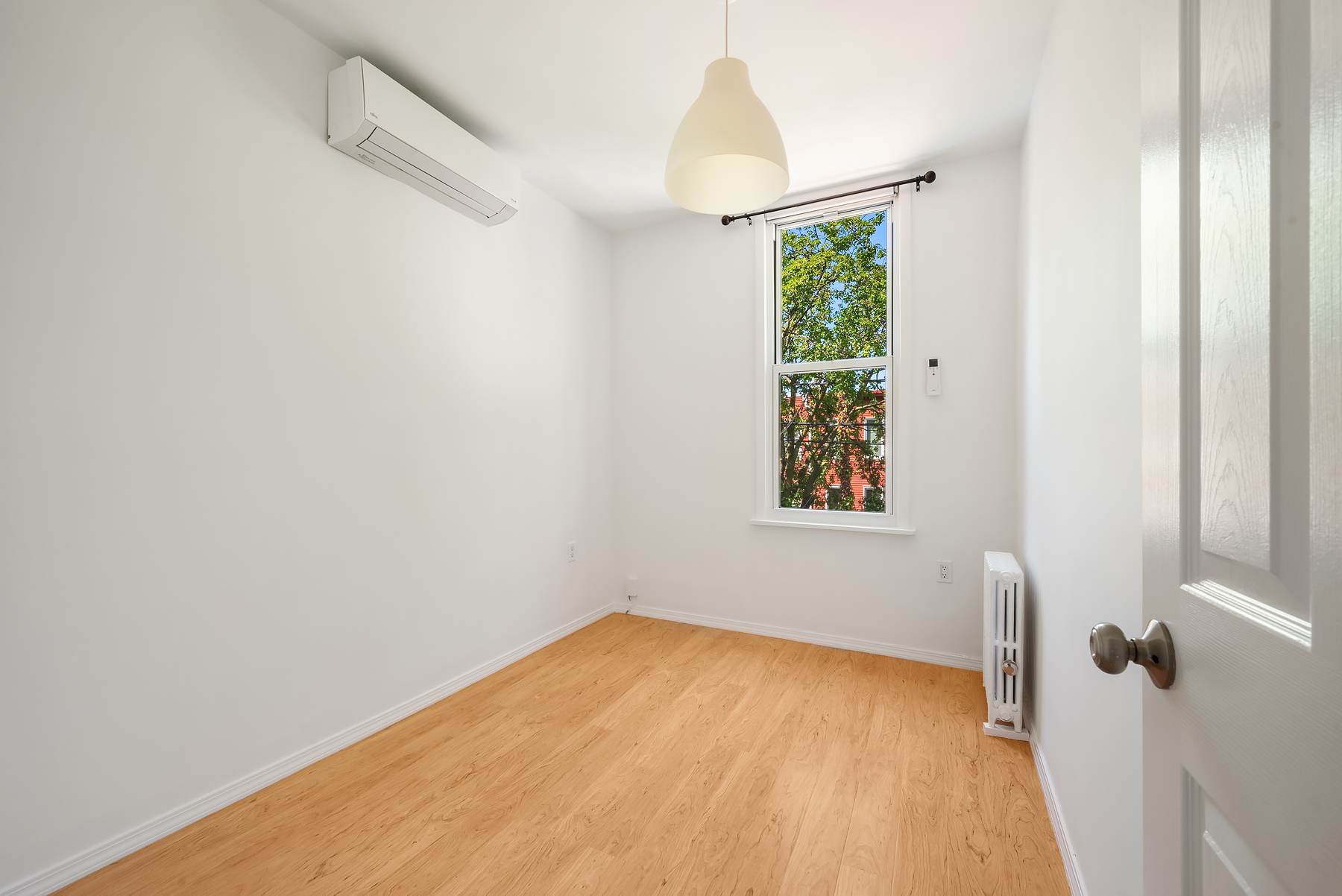 115 Jewel Street, Unit 2L Brooklyn, NY 11222 - Photo 4 of 6 a view of an empty room with a window