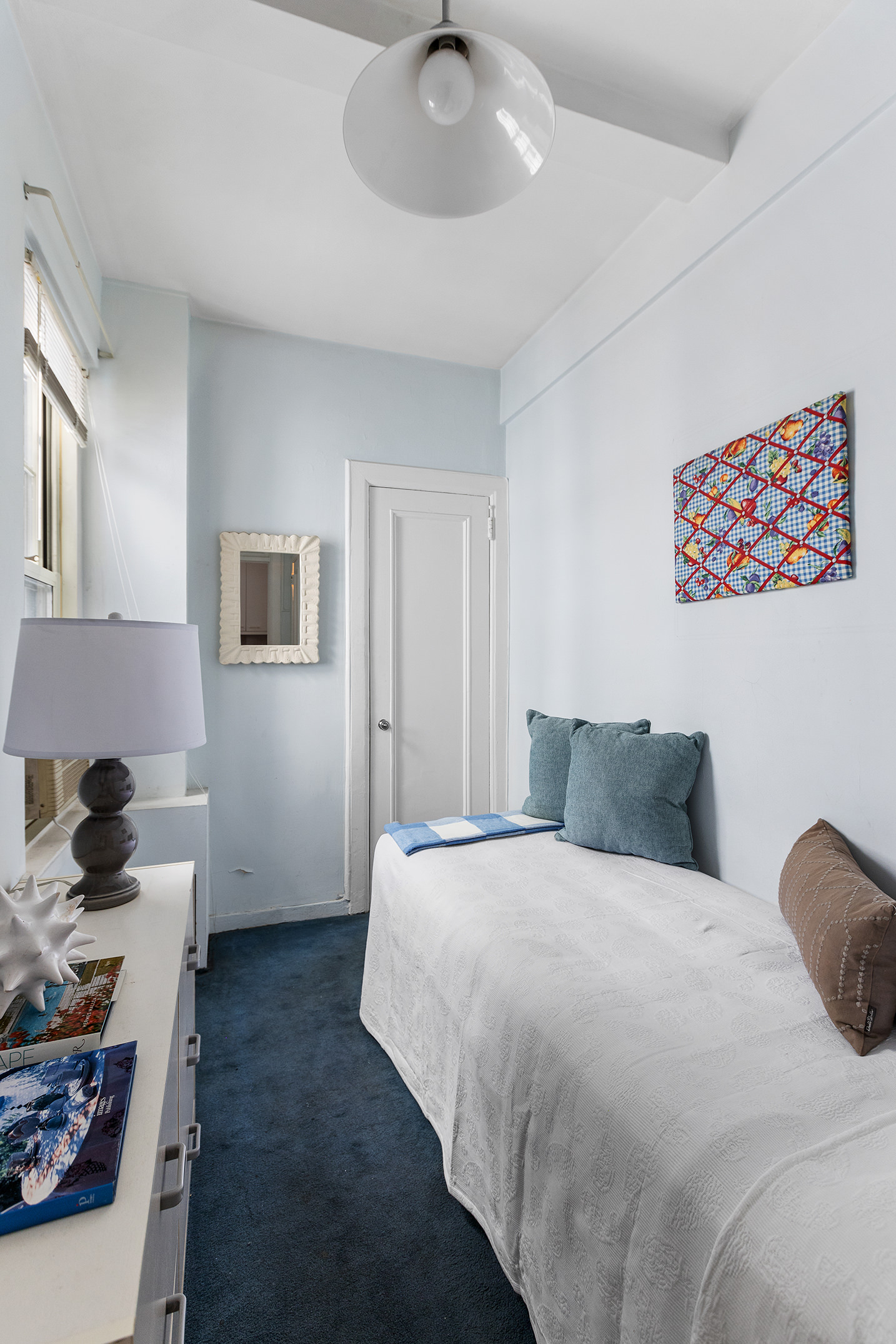 125 East 63rd Street, Unit 2B Manhattan, NY 10065 - Photo 10 of 12 a bedroom with a bed and a chandelier