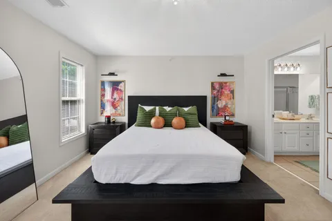 a bedroom with a bed and a flat screen tv