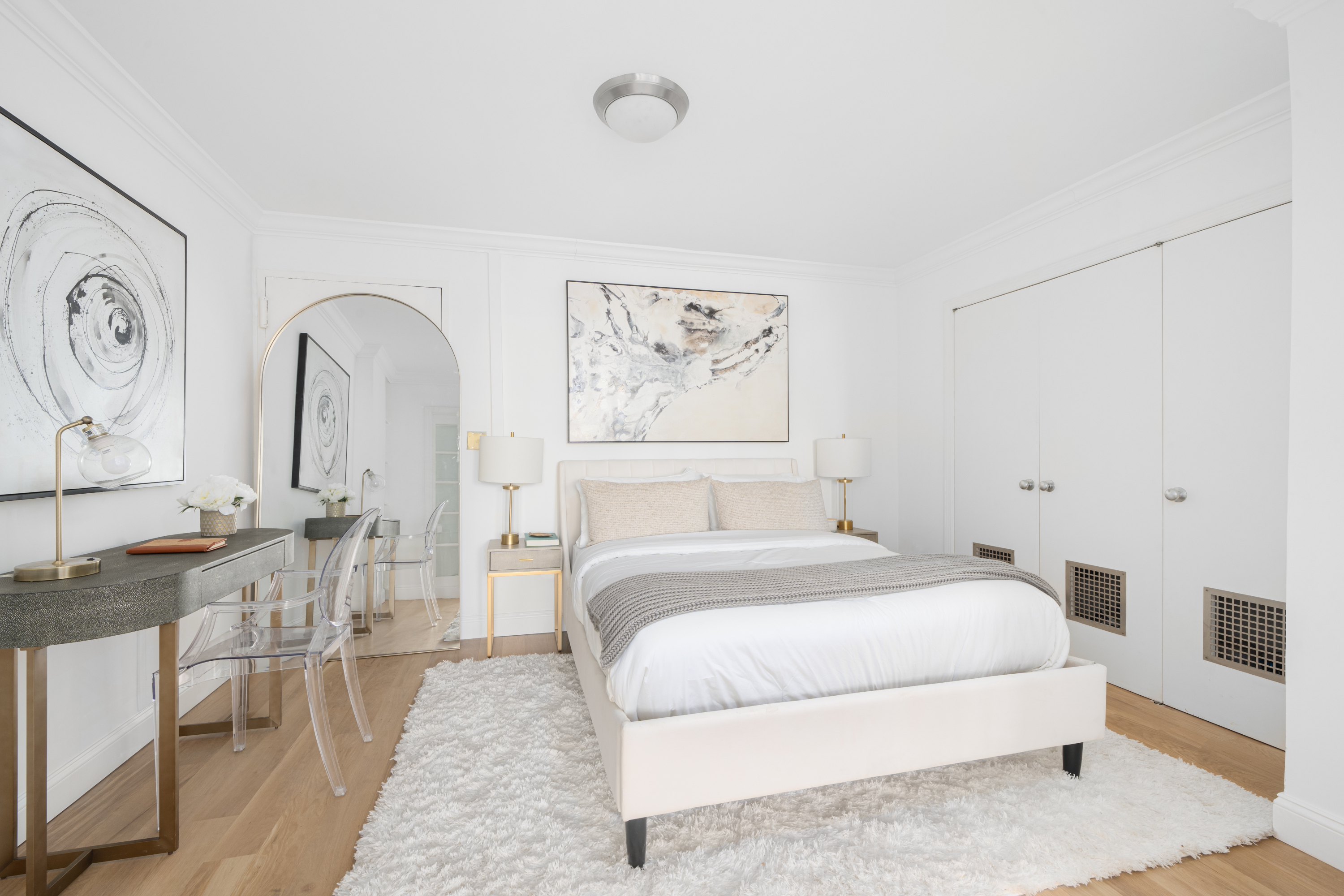 360 West 22nd Street, Unit 15C-14C Manhattan, NY 10011 - Photo 13 of 16 a spacious bedroom with a bed a table and painting on the wall
