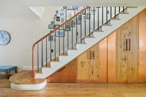 a view of entryway and hall with wooden floor